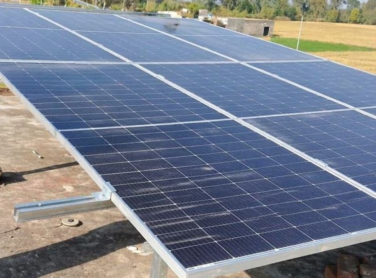 Solar panels in a farm field in Haryana